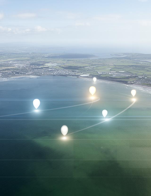 Aerial view of the Irish Sea with Dublin and Belfast marked by illuminated route points on a planning board